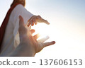 A desperate Christian hand reaching out to the hand of Jesus Christ, with a bright sunny background, concept of faith and salvation. 137606153