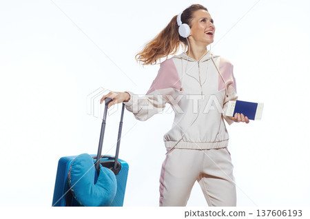 Smiling Woman Traveler Walking with Suitcase and Passport 137606193