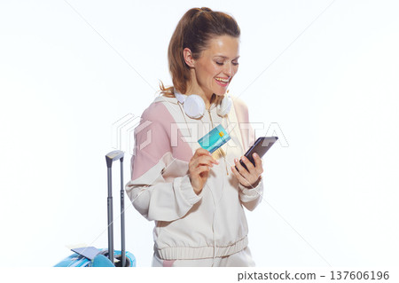 Woman Booking Travel with Smartphone and Credit Card 137606196