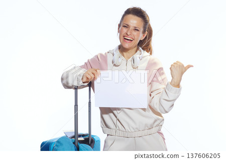 Happy Traveler Pointing at Blank Sign with Suitcase Happy Traveler Pointing at Blank Sign with Suitcase 137606205