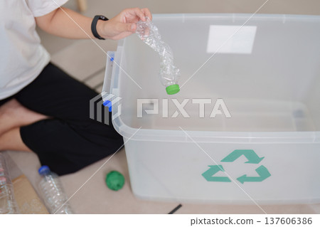 Recycling. Close-up of woman sorting plastic waste into recycling bin. Recycling. Close-up of woman sorting plastic waste into recycling bin. 137606386