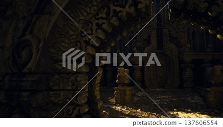 Closeup of carved arch leading toward dimly lit chamber with scattered coins and ornate reliefs, intimate texture study with cinematic lowkey lighting. Closeup of carved arch leading toward dimly lit chamber with scattered coins and ornate reliefs, intimate texture study with cinematic lowkey lighting. 137606554