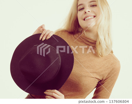 Woman wearing suede and black hat 137606804