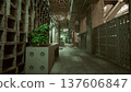 deserted industrial corridor lined lockers and concrete walls under moody green lighting, scattered planter boxes and metal grates night janitor inspects 137606847