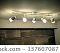 Duct rail spotlights installed on the beams of an apartment building and Ecocarat walls 137607087