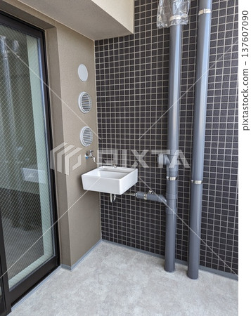 Example of installation of a slop sink and drainage pipe on the balcony of a newly built apartment building 137607090