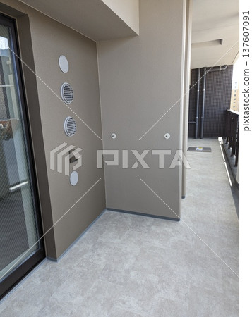 A spacious balcony and exterior wall vents and outlets in a newly built apartment building 137607091