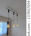 A modern pendant light installed on a duct rail in an apartment building 137607094