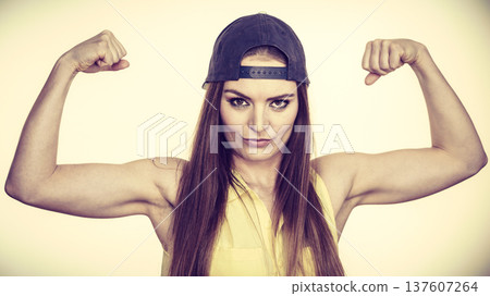 Woman casual style showing off muscles biceps Woman casual style showing off muscles biceps 137607264