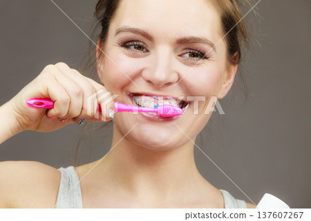 Woman brushing cleaning teeth Woman brushing cleaning teeth 137607267