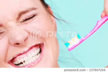 Woman brushing cleaning teeth 137607268