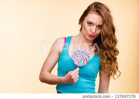 Woman joyful girl with lollipop candy Woman joyful girl with lollipop candy 137607276