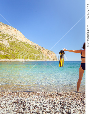 Woman with flippers snorkeling tube on beach Woman with flippers snorkeling tube on beach 137607463