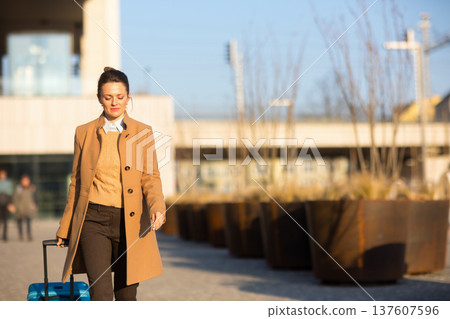 Modern Railway Traveler in Urban Station Environment Modern Railway Traveler in Urban Station Environment 137607596