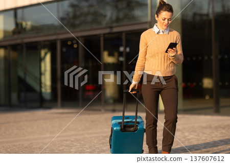Business Woman Planning Route at Train Station Plaza 137607612