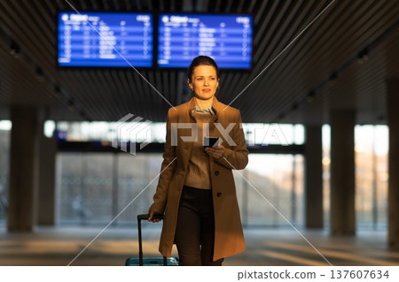 Confident Female Traveler at Train Station Entrance 137607634