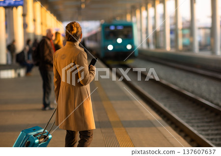 Woman Using Tablet on Train Station Platform 137607637