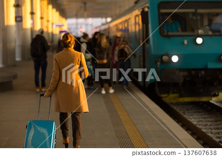 Woman Walking Toward Train on Platform Woman Walking Toward Train on Platform 137607638