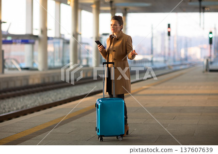 Woman Talking on Phone at Modern Train Station Woman Talking on Phone at Modern Train Station 137607639