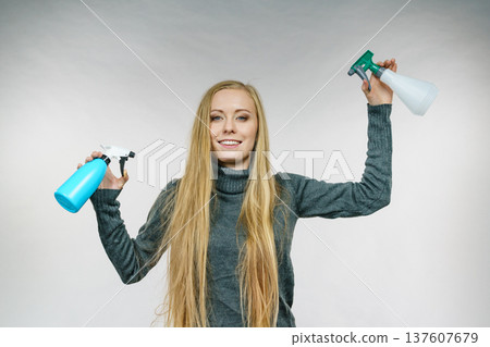 Female messy long hair holds spray bottle Female messy long hair holds spray bottle 137607679