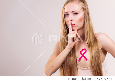 Woman pink cancer ribbon on breast 137607688
