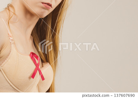 Woman chest in bra, pink cancer ribbon Woman chest in bra, pink cancer ribbon 137607690