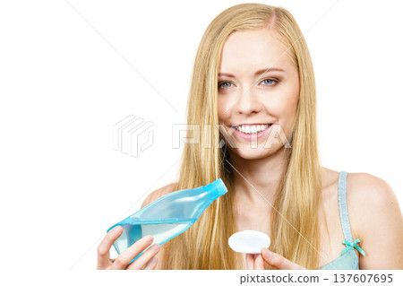 Woman using cleanser cosmetic 137607695
