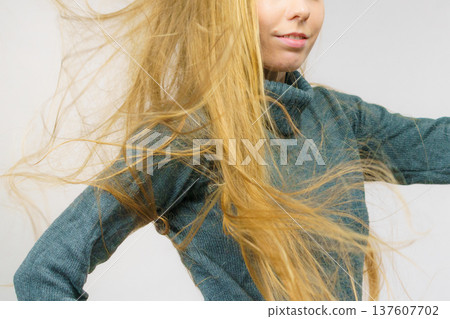Smiling woman with blowing long hair Smiling woman with blowing long hair 137607702