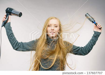 Girl holds hair accessories, styling hair Girl holds hair accessories, styling hair 137607707