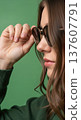 Close up of an anonymous hand adjusting stylish round sunglasses on a head 137607791