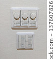 LED dimmer switch (light control) and name-printed switch panel installed in the living room of an apartment building 137607826