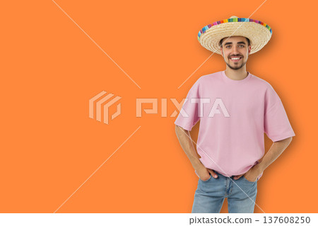 Cinco de Mayo, Man wearing a sombrero stands smiling and showing joy 137608250