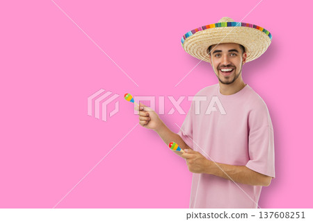 Cinco de Mayo, Man in sombrero plays maracas to celebrate Cinco de Mayo, Man in sombrero plays maracas to celebrate 137608251