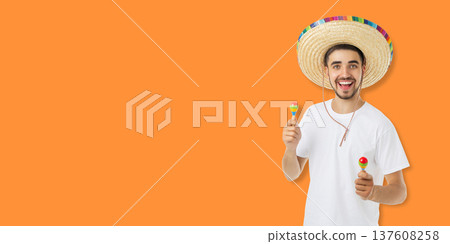 Man celebrates Cinco de Mayo with maracas and sombrero 137608258