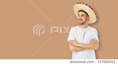 Cinco de Mayo, Young man in sombrero smiles and poses for celebration Cinco de Mayo, Young man in sombrero smiles and poses for celebration 137608261
