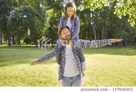 Happy young father with child boy having fun and playing plane at sunny day in nature. Happy young father with child boy having fun and playing plane at sunny day in nature. 137608365