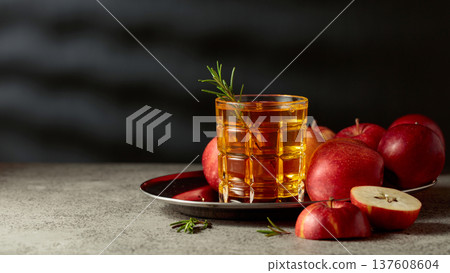 Apple juice and fresh apples on an old kitchen table. 137608604