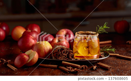 Apple drink with fresh apple slices and a rosemary branch. 137608605