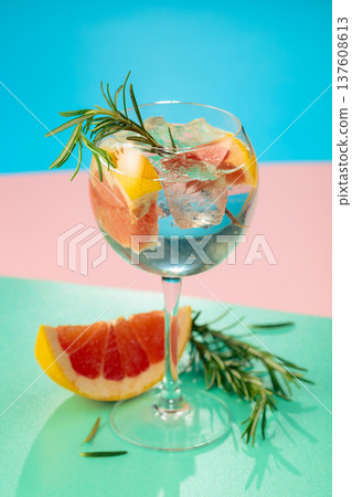 Cocktail with gin, tonic, grapefruit, and rosemary. 137608613