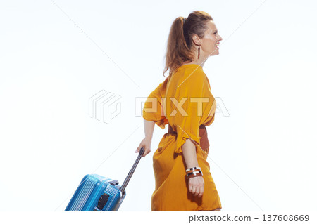 Smiling Woman Walking with Suitcase for Holiday Trip 137608669