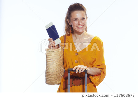 Woman Holding Passport High with Blue Suitcase and Bag Woman Holding Passport High with Blue Suitcase and Bag 137608672
