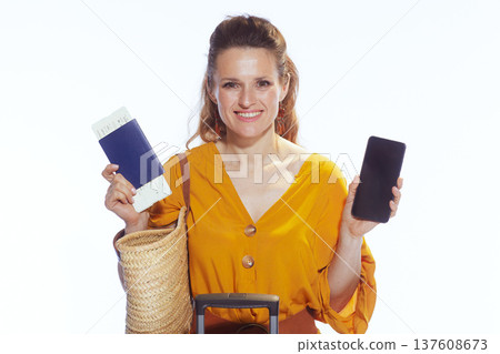 Woman Using Smartphone and Holding Passport for Travel Booking 137608673