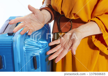 Traveler Reacting to Damaged Suitcase With Frustration Traveler Reacting to Damaged Suitcase With Frustration 137608683