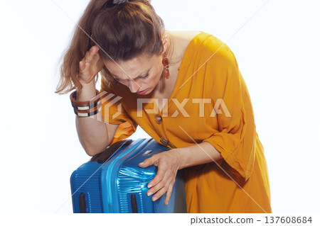 Upset Traveler Holding Head Over Damaged Suitcase 137608684