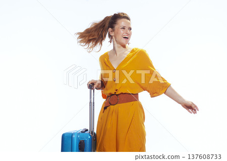 Joyful Woman Pulling Blue Suitcase on Holiday Joyful Woman Pulling Blue Suitcase on Holiday 137608733