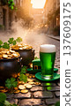 Green beer in a glass sits beside pots of gold coins and shamrocks on a cobblestone street, illuminated by warm sunlight during Saint Patrick's Day celebration 137609175