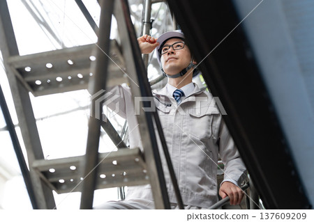 Men in work clothes outdoors scaffolding Men in work clothes outdoors scaffolding 137609209