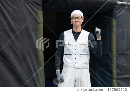 Men in work clothes, knickerbockers, fist pump Men in work clothes, knickerbockers, fist pump 137609220