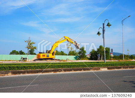 Excavator on road construction. Screeding ground for installing borders, curbs blocks at road. Excavator on road construction. Screeding ground for installing borders, curbs blocks at road. 137609240