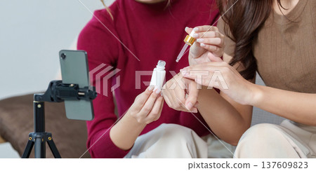 Skincare Routine. Friends demonstrating product application in a beauty tutorial. Skincare Routine. Friends demonstrating product application in a beauty tutorial. 137609823